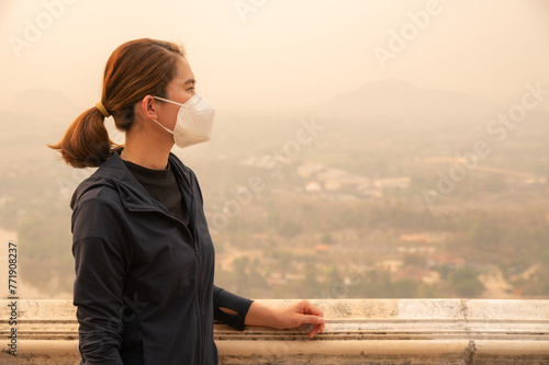 Asian woman wearing an N95 mask for protect bad air pollution. PM2.5 levels meaning the air quality posed a health hazard.