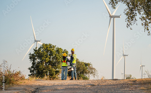 Engineers are working with wind turbines, Green ecological power energy generation, and sustainable windmill field farms. Alternative renewable energy for clean energy concept.