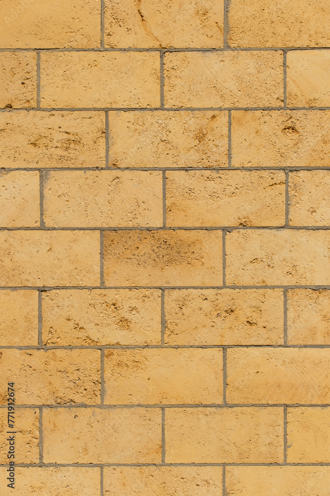 Naklejka premium Brickwork brick masonry wall light background architecture facade exterior building sand color limestone shell