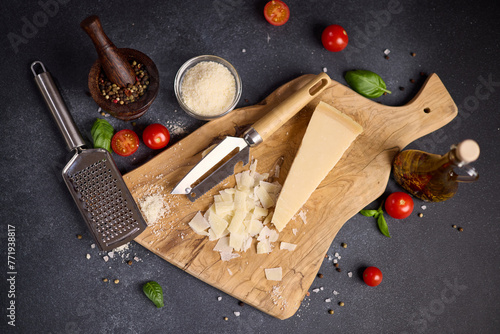 Piece of Traditional Italian Parmesan Hard cheese on a wooden cutting board at domestic kitchen © Anatoly Repin