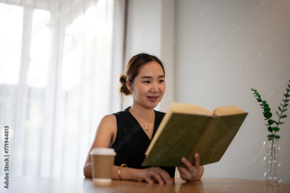 Businesswoman Reading Book in Peaceful Office Setting Businesswoman Reading Book in Peaceful Office Setting