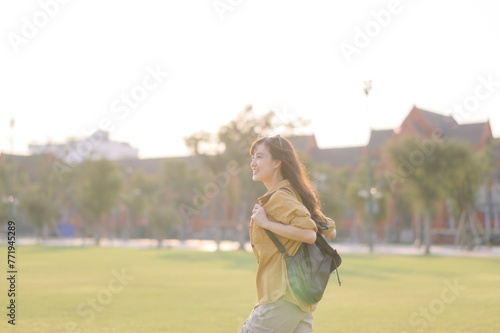 Traveler asian woman in her 30s stands bathed in the golden glow of sunset, embracing the freedom of exploration. on summer holiday weekend vacation trip in Bangkok, Thailand