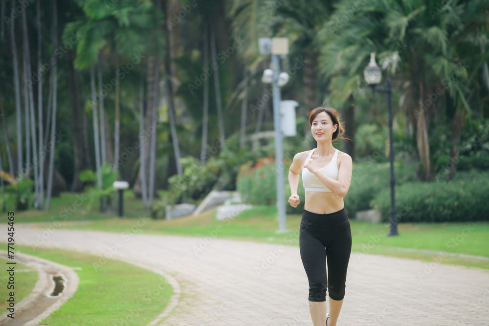 asian woman jogger running in green nature public park. asian woman jogger running in green nature public park.
