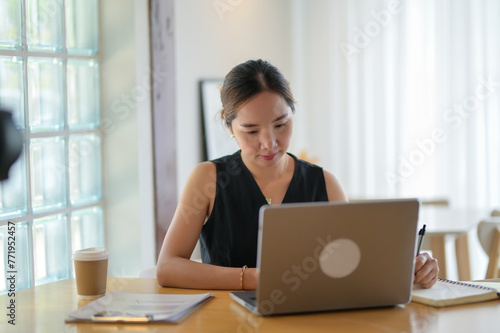 Focused Entrepreneur Working on Laptop with Coffee