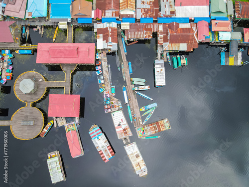 Tourist boats are parked at the Kereng Bengkirai pier as seen from the air. Kereng Bengkirai is a tourist destination in the Sebangau national park area, Palangkaraya, Central Kalimantan, Indonesia. photo