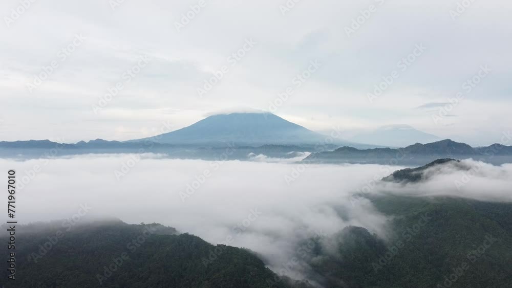 mountains and sea of clouds under a cloudy sky, in the morning mountains and sea of clouds under a cloudy sky, in the morning
