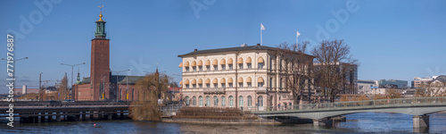 Panorama. The Town City Hall, an old yellow office building in the island Strömsborg, bridges and central train station in Stockholm a sunny spring day