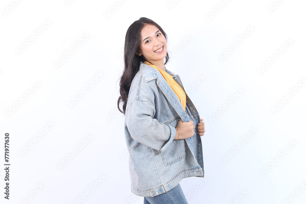 Cheerful Asian woman with confident smile looking at camera wearing blue jacket and yellow t-shirt isolated white background Cheerful Asian woman with confident smile looking at camera wearing blue jacket and yellow t-shirt isolated white background