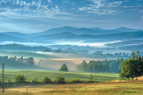 A Pastoral Landscape Enveloped in Early Morning Mist: Distant Mountains and Fields Shrouded in Fog Create a Fantastical Tranquility and Beauty
