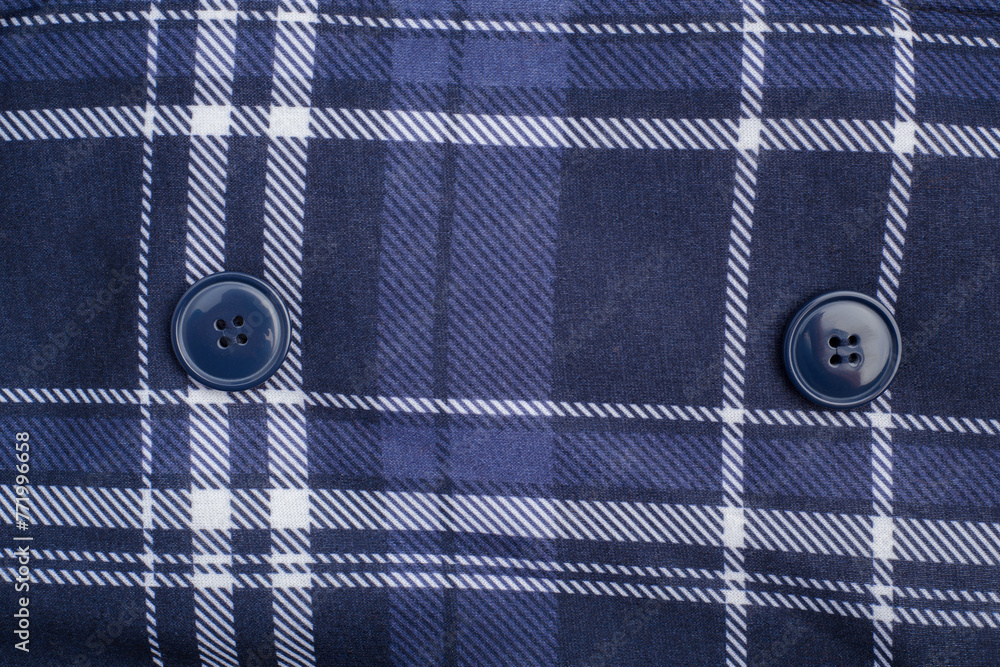Fabric with blue and white crossed lines and buttons. Textile texture. Fabric with blue and white crossed lines and buttons. Textile texture.