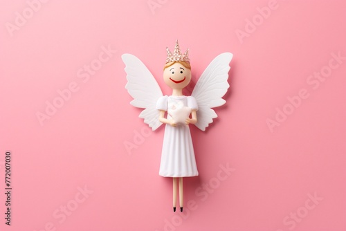 a toy angel with wings and crown