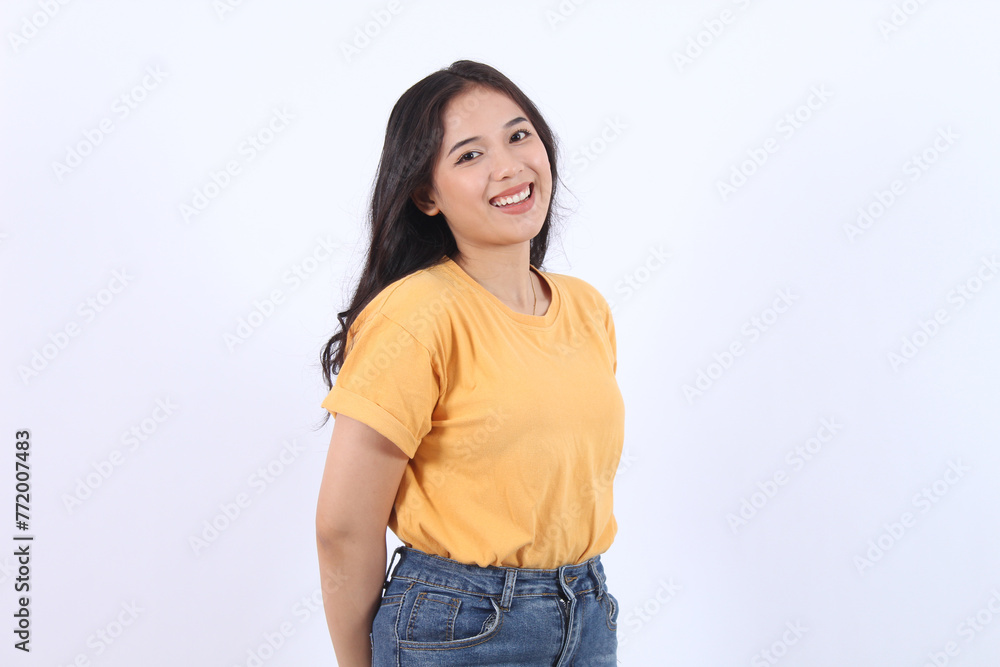 Cheerful Asian woman with confident smile looking at camera wearing yellow t-shirt isolated white background Cheerful Asian woman with confident smile looking at camera wearing yellow t-shirt isolated white background