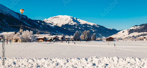 Alpine winter wonderland view with a hot air balloon near Tannheim, Reutte, Tyrol, Austria photo