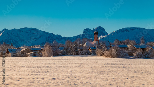 Alpine winter wonderland view with a church near Seeg, Ostallgaeu, Bavaria, Germany photo