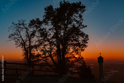 Sunset with a memorial silhouette at Mount Bogenberg, Bogen, Danube, Bavaria, Germany photo