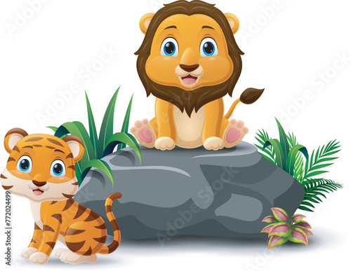 Cartoon baby lion and tiger sitting on the stone © dreamblack46