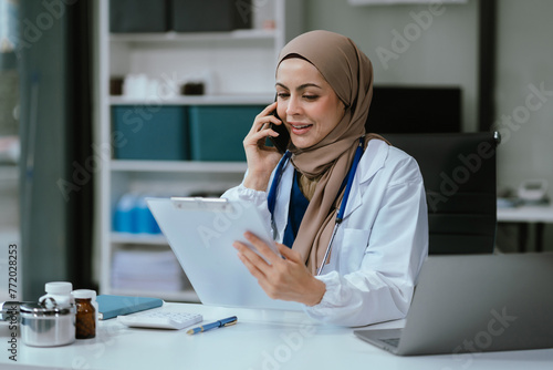 Wallpaper Mural Female medicine doctor, physician or practitioner involved in cellphone call conversation giving professional consultation to patients. Medic tech concept. Torontodigital.ca