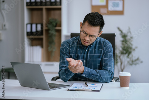 Business men have wrist pain after work hard in office feeling so pain and illness with Office syndrome symptom, healthcare office syndrome concept.