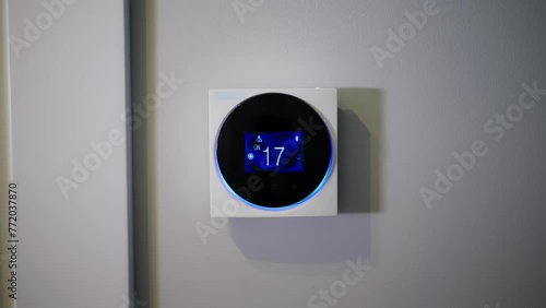 Setting the temperature in the room. Setting the house temperature via the thermostat. Setting the thermostat manually. Air conditioner. Digital thermostat. Hotel. Remote control thermostat. A man
