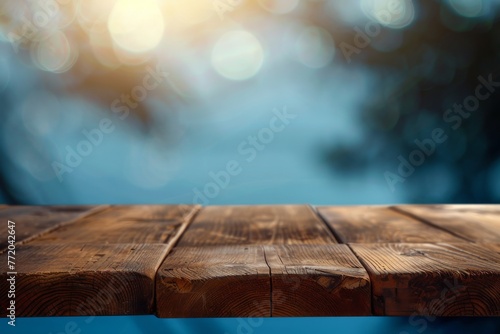 wooden table with blue blur background space banner display or montage your products.