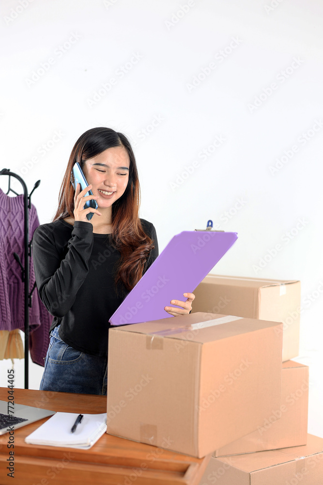 Asian Female Small Business Owner, Happy Face While Calling using Smartphone