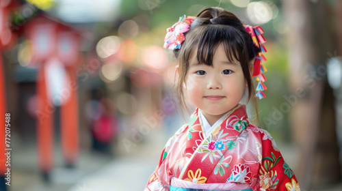 celebration of the Founding Day of the State of Japan, portrait of a little girl in a national Japanese costume, a cute child in a geisha outfit, against the background of the Japanese quarter