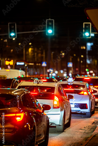 Cars in a traffic jam in the center of a big city at night.