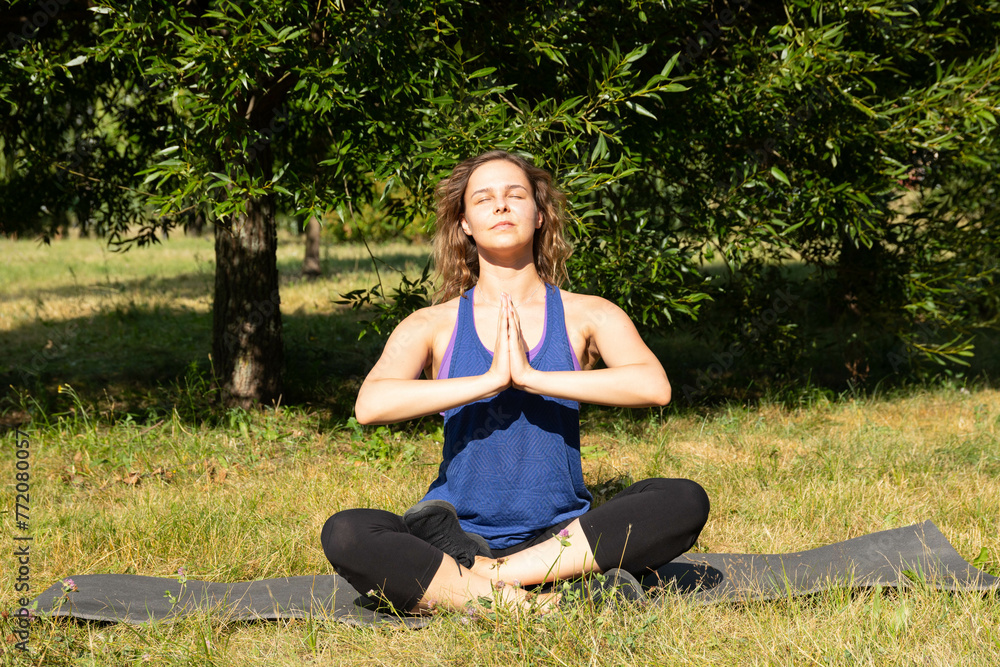 Female fitness instructor does, shows exercises in a green park. Sport concept. Female fitness instructor does, shows exercises in a green park. Sport concept.
