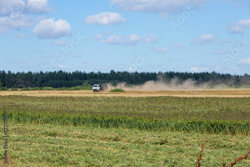 Truck loaded with millet in the countryside, driving across the field.