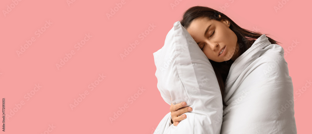 Sleepy young woman with blanket and pillow on pink background Sleepy young woman with blanket and pillow on pink background