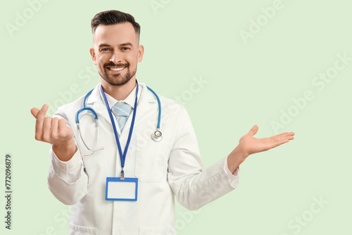 Male doctor making heart wi...
