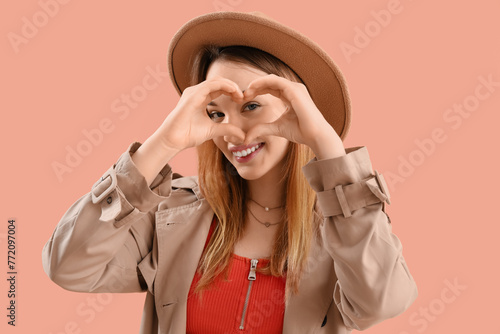 Young woman making heart wi...
