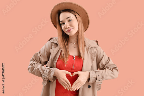 Young woman making heart wi...