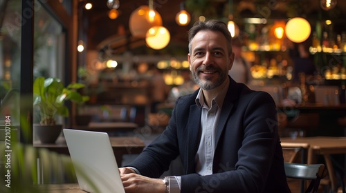 Celebratory Businessman with Laptop in Blurred Urban Environment, Celebratory, businessman, laptop, blurred urban environment