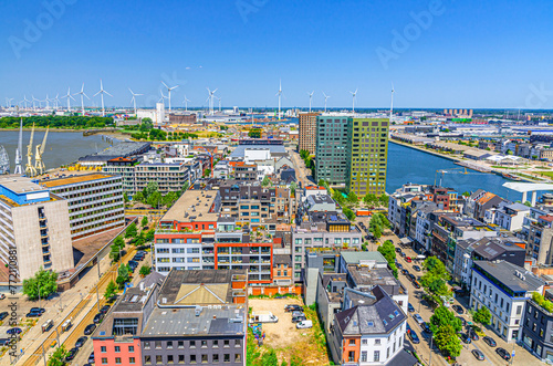 Antwerp cityscape, aerial panoramic view of Antwerp city Eilandje quarter neighborhood with port area, water canals, windmills on skyline horizon, panorama of Antwerpen, Flemish Region, Belgium © Aliaksandr