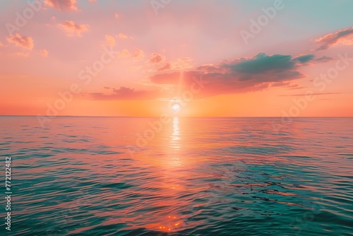 : A vibrant sunset over the ocean, with a warm orange and pink sky and a peacefully calm sea photo