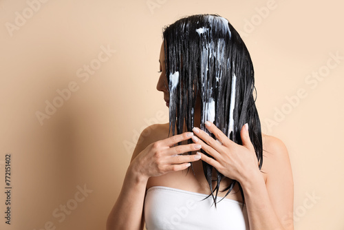 Young woman applying hair m...