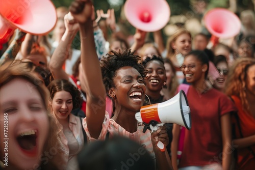 Photo portrait of a black woman with megaphone at rally organized for women. Theme of gender equality, women's rights, solidarity, fight for the rights of people of color, female gender. photo