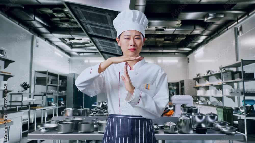 Asian Woman Chef Looking At Camera And Showing Time Out Hands Gesture In Professional Kitchen Asian Woman Chef Looking At Camera And Showing Time Out Hands Gesture In Professional Kitchen