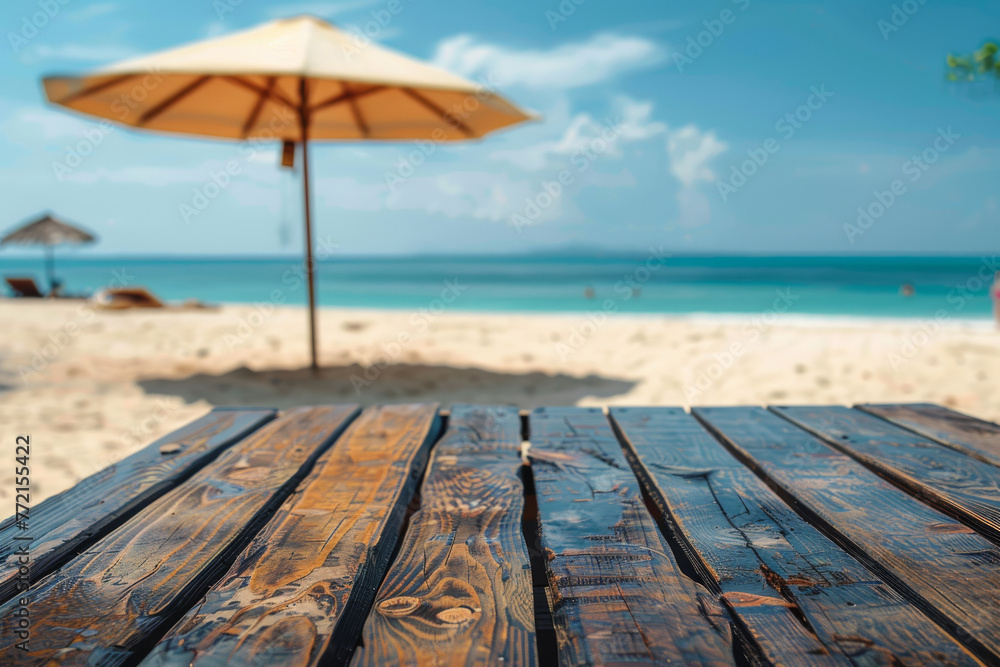 Fototapeta premium Tropical Beach Escape: Sunlit Umbrella and Wooden Table Overlooking Ocean
