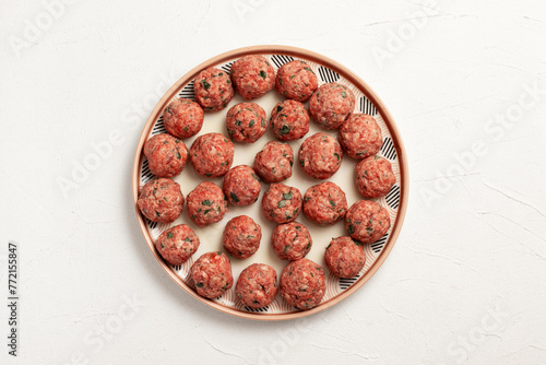 Raw meatballs on a plate. Top view.