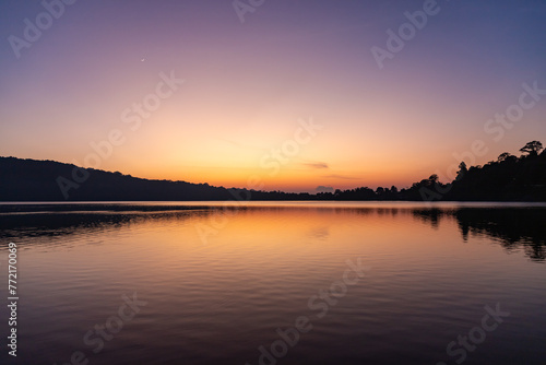 Views of the sunrise at Lake Beratan with boats on shore, Bali © umike_foto