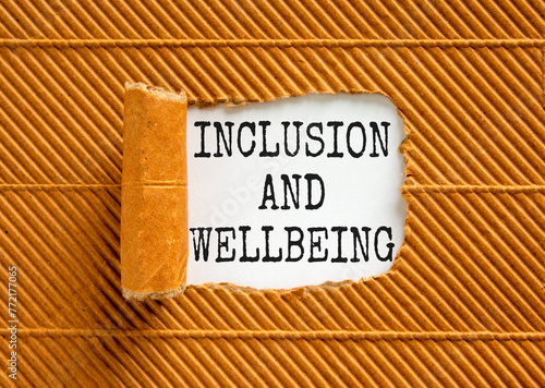 Inclusion and wellbeing symbol. Concept words Inclusion and wellbeing on beautiful white paper. Beautiful brown background. Motivational inclusion and wellbeing concept. Copy space.