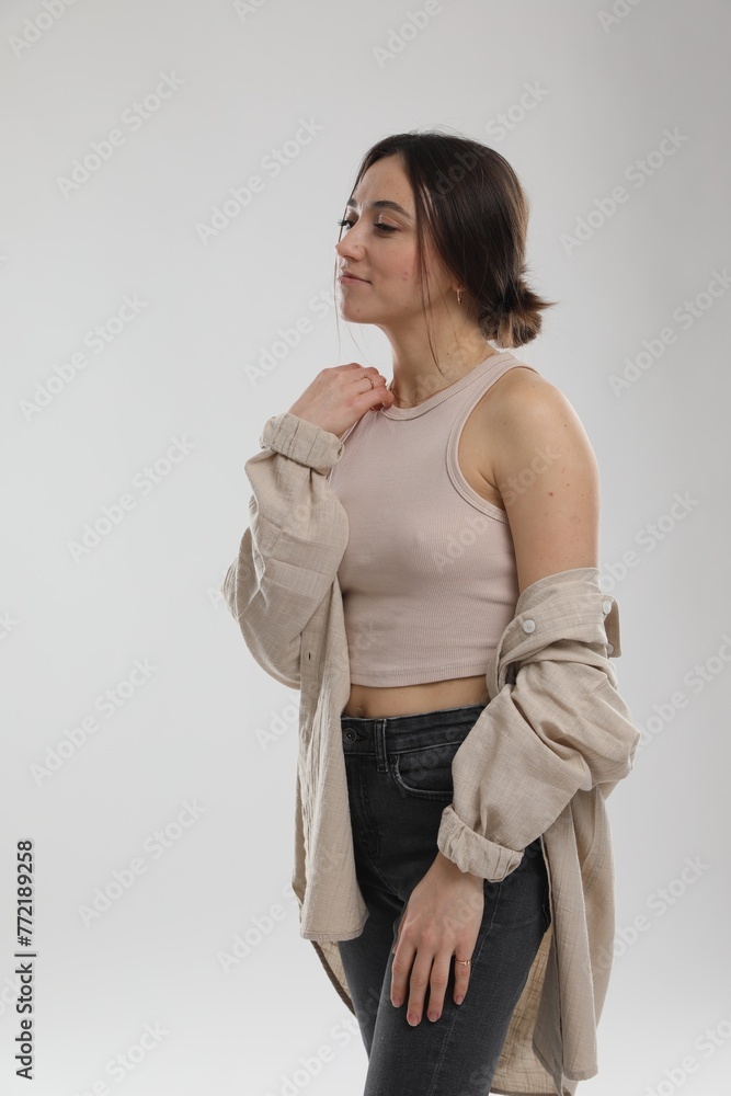 Portrait of beautiful woman on light grey background Portrait of beautiful woman on light grey background