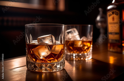 Two whiskey drinks on the wood counter in the bar