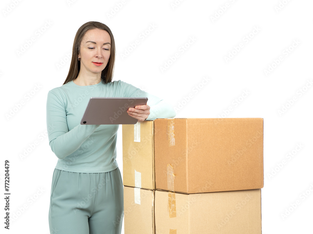 Woman with tablet near boxes. Logistics and parcel delivery. Owner of courier business. Girl received boxes from delivery service. Woman sends courier parcels. Businesswoman standing on white