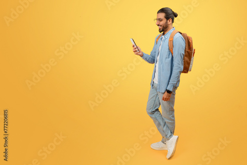 Walking man engaged with his smartphone