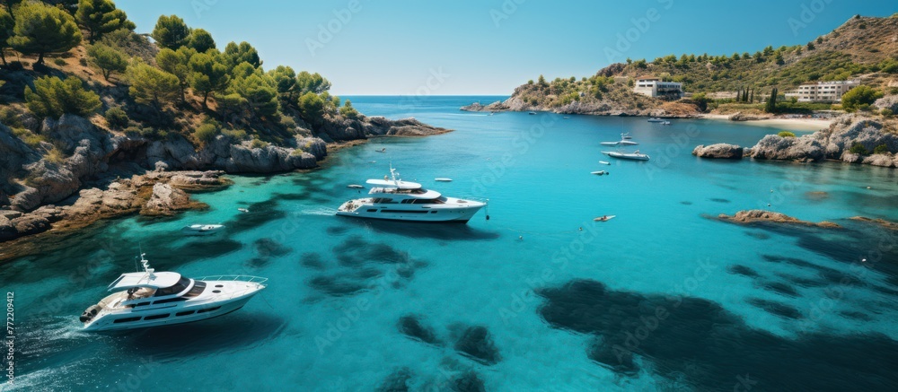 Aerial view of turquoise water bay with luxury yachts and sailboats