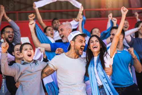 Football / soccer fans are cheering for their team at the stadium on the match