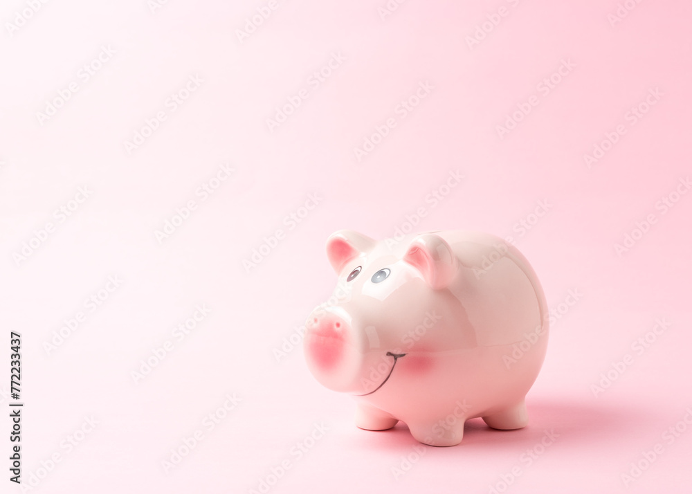 Piggy bank on pink background. Saving money concept.
